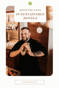 You can see the bartender of a sustainable hotel. He holds a shaker in his hand and laughs into the camera