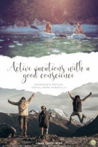 Two people are kayaking on a lake, and three people are standing with their arms raised in front of snow-capped mountains