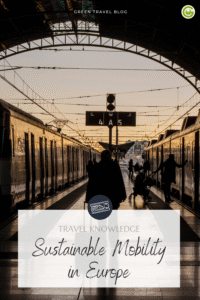 In the foreground is a person carrying luggage, walking on a train platform between two trains. The scene is bathed in warm light streaming through the station’s glass roof. At the bottom is a semi-transparent box bearing the inscription “REISEWISSEN: Sustainable Mobility in Europe.” 