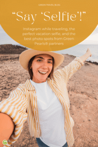 A young woman wearing a beige hat and a light-colored sweater is standing on a rocky coastal path, holding out one arm as if she were taking a selfie. In the upper part of the image is a yellow circle with white text. The background shows the ocean and a cloudy sky.